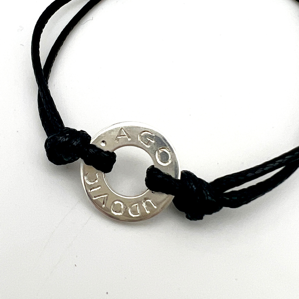 bracciale rondella in argento artigianale con incisione personalizzabile e cordino disponibile nero, arancione, rosa o azzurro.