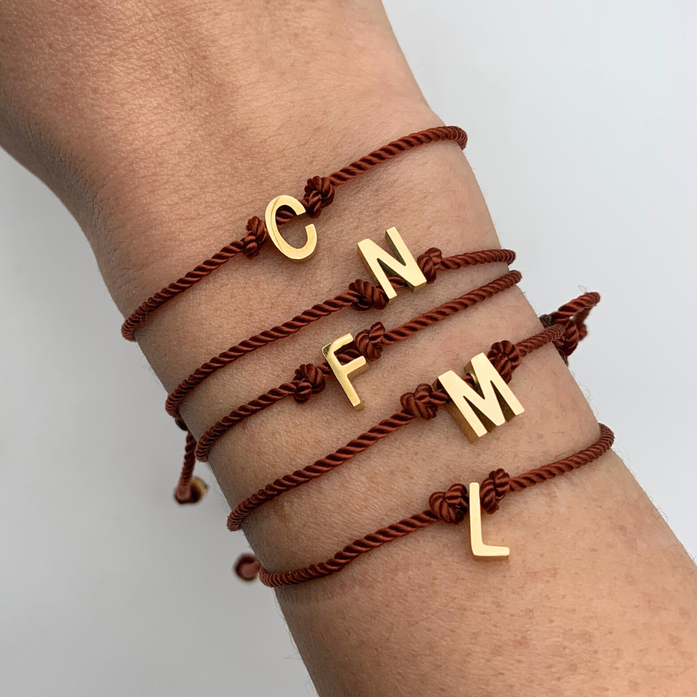 bracciale con cordino rosso ramato torchon con chiusura scorrevole e lettera personalizzata in acciaio gold