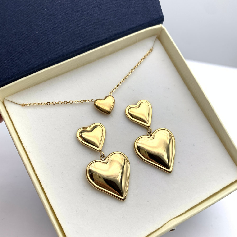 orecchini in acciaio inox gold con due cuori uno pendente